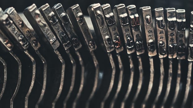 Letters and numbers on typo keys of an old manual typewriter on a retro writing machine, close up view