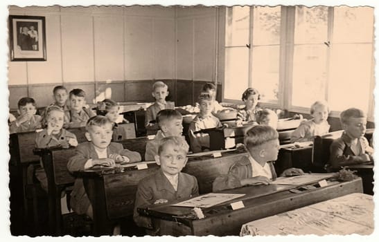 THE CZECHOSLOVAK SOCIALIST REPUBLIC - CIRCA 1950s: Retro photo shows pupils sit at the wooden school desks in the classroom.