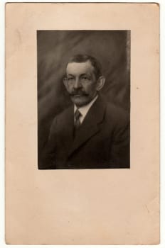 THE CZECHOSLOVAK REPUBLIC - CIRCA 1930s: Vintage photo shows man. Photo with wide frame. Black white studio portrait.