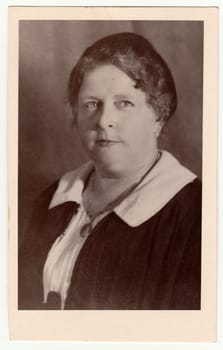 LIBEREC (REICHENBERG), THE CZECHOSLOVAK REPUBLIC - CIRCA 1930s: Vintage photo shows a mature woman poses in a photography studio. Black white studio portrait.