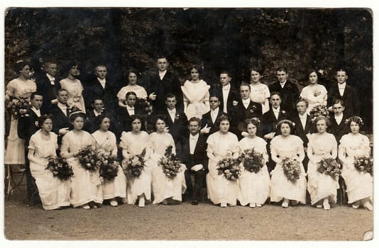 LIBEREC (REICHENBERG), THE CZECHOSLOVAK REPUBLIC - CIRCA 1920s: Vintage photo shows sixteen couples take dance lessons. The couples pose for photographer. Black white antique studio portrait.