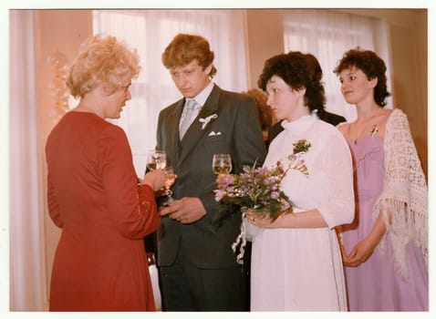THE CZECHOSLOVAK SOCIALIST REPUBLIC - CIRCA 1980: Vintage photo shows wedding's celebratory drink after wedding ceremnony. Colour photography.