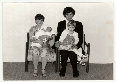 THE CZECHOSLOVAK SOCIALIST REPUBLIC - CIRCA 1980s: Vintage photo shows parents with their children. Antique black white photo.