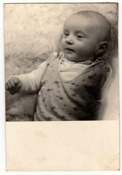 THE CZECHOSLOVAK SOCIALIST REPUBLIC - CIRCA 1980s: Vintage photo shows baby boy. Antique black white photo.