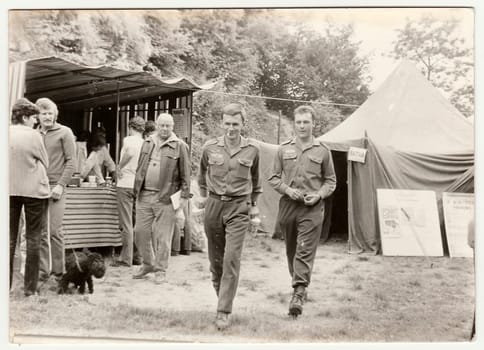 THE CZECHOSLOVAK SOCIALIST REPUBLIC - CIRCA 1980s: Vintage photo shows soldiers at the village celebration. Antique black white photo.