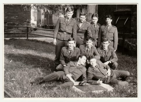 THE CZECHOSLOVAK SOCIALIST REPUBLIC - CIRCA 1970s: Vintage photo shows soldiers pose in front of barracks. Black & white antique photo.