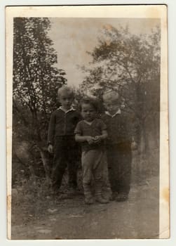 THE CZECHOSLOVAK SOCIALIST REPUBLIC - CIRCA 1960s: Vintage photo shows boys pose outdoors. Antique black white photography.