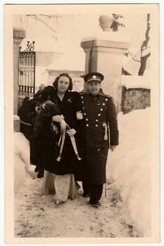 PRAGUE, THE CZECHOSLOVAK SOCIALIST REPUBLIC - CIRCA 1950s: Vintage photo shows newlyweds after wedding ceremony in the church. Wedding ceremony happens in winter.
