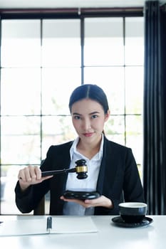 Portrait of a beautiful Asian lawyer studying a lawsuit for a client before going to court.