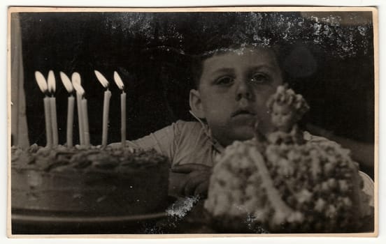 THE CZECHOSLOVAK SOCIALIST REPUBLIC - CIRCA 1950s: Vintage photo shows boy celebrates his 7th birthday. Black white photography.