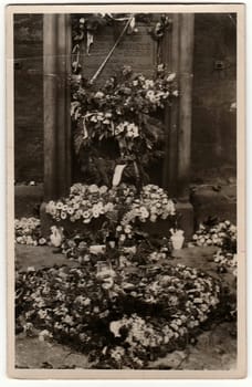 THE CZECHOSLOVAK REPUBLIC - CIRCA 1930s: Vintage photo shows tomb with funeral wreath and flowers. Black white antique photography.