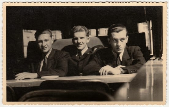 THE CZECHOSLOVAK REPUBLIC - CIRCA 1960s: Vintage photo shows men sit at a coffee bar. Black white antique photography.