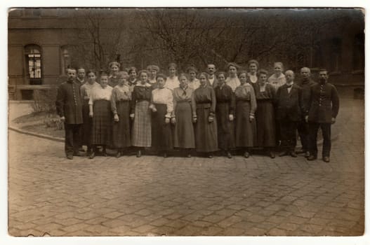 GERMANY - CIRCA 1920s: Vintage photo shows a big group of people pose outdoors. Black white antique photography.