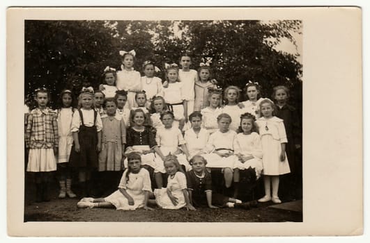 GERMANY - CIRCA 1940s: Vintage photo shows group of girls (schoolmates, pupils) pose outdoors. Black white antique photography.