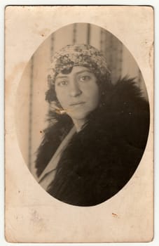 THE CZECHOSLOVAK REPUBLIC - CIRCA 1940s: Vintage photo shows an elegant woman wears fur scarf. Antique black white photo is oval shaped.