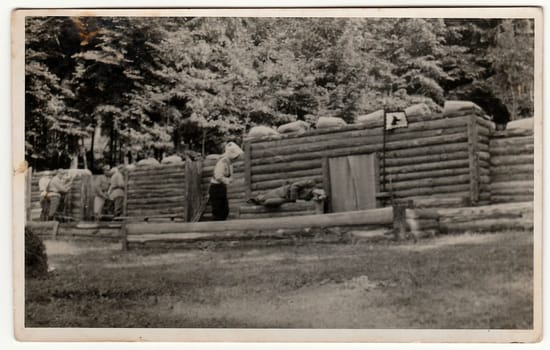 THE CZECHOSLOVAK REPUBLIC - CIRCA 1938: Vintage photo shows soldiers in front of log fortification. Black white antique photography.