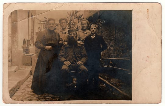 RUSSIA - CIRCA 1920s: Vintage photo shows rural family poses outdoors. Black white antique photography.