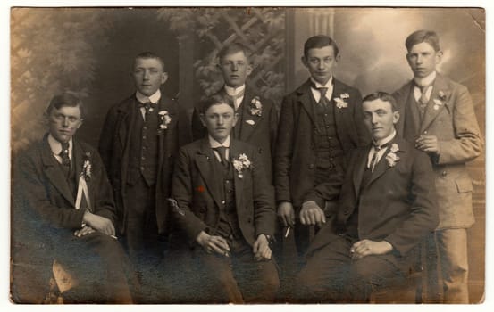 EILENBURG, GERMANY - CIRCA 1930s: Vintage photo shows young men (recruiters) pose at the photography studio. Black white antique photography.