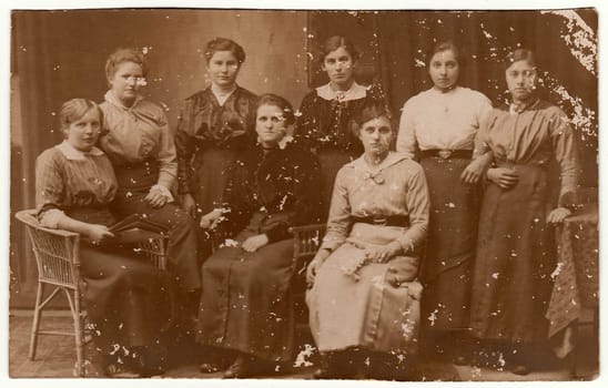 GERMANY - CIRCA 1930s: Vintage photo shows group of women pose at the photography studio. Black white antique photography.