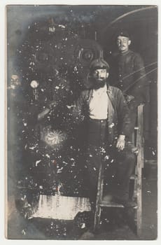 THE CZECHOSLOVAK REPUBLIC - CIRCA 1930s: Vintage photo shows workers pose in old steelworks. Black white antique photography.