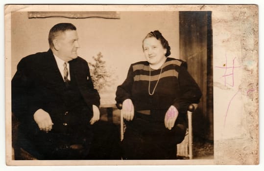 KLATOVY, THE CZECHOSLOVAK REPUBLIC - CHRISTMAS, CIRCA 1950s: Vintage photo shows an elderly couple during the Christmas. Black white antique photography.