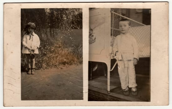 MALENICE (VOLARY), THE CZECHOSLOVAK REPUBLIC - JULY 15, 1931: Vintage photo shows boy wears pyjamas, he stands next to an iron bed and a small girl poses outdoors. Black white antique photography.