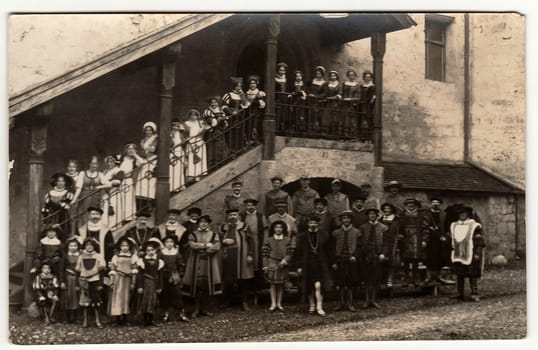 THE CZECHOSLOVAK SOCIALIST REPUBLIC - CIRCA 1950s: Vintage photo shows a big group of people (actors and actresses) in historic costumes. They stands in the castle courtyard.