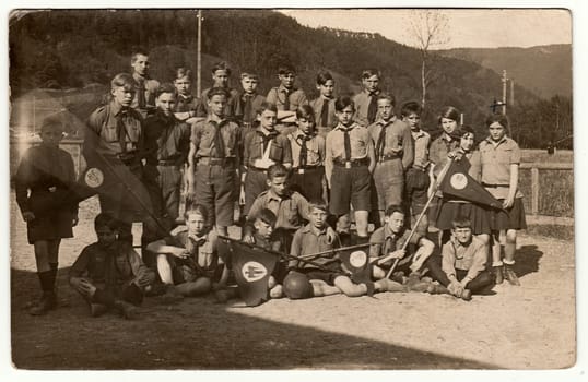 GERMANY - CIRCA 1940s: Vintage photo shows boy and girl scouts (pfadfinder) outdoors. Black white antique photography.