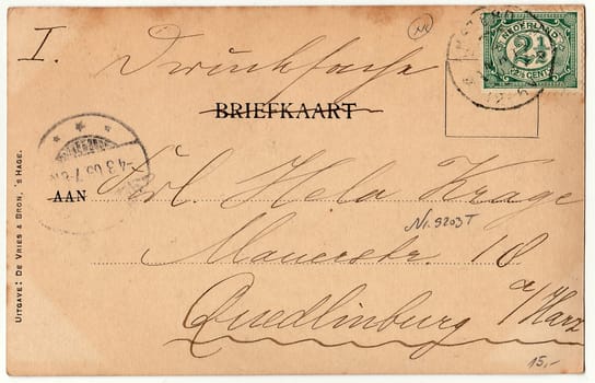 AMSTERDAM, THE NETHERLANDS - MARCH 3, 1903: Back of a vintage photo - used postcard. Rich stain and paper details. Can be used as background. Image contains handwriting.