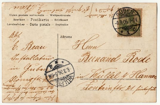 GUBEN, GERMANY - MARCH 6, 1906: Back of a vintage photo - used postcard. Rich stain and paper details. Can be used as background. Image contains handwriting.