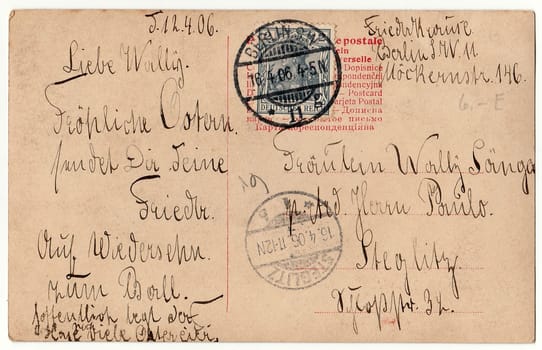 BERLIN, GERMANY - APRIL 12, 1906: Back of a vintage photo - used postcard. Rich stain and paper details. Can be used as background. Image contains handwriting.