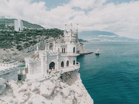 Aerial view of Swallow's Nest castle on the rock in Black Sea. It is a symbol and landmark of Crimea. Beautiful scenic panorama of the Crimea coast. Amazing Swallow's Nest at the precipice.