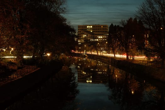 Building reflected in the Spree river at night in autumn in Berlin, Germany