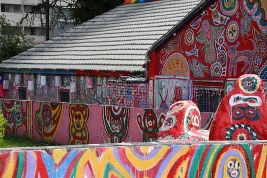 Houses with colorful interesting cartoon paintings on the walls in Caihong, Taichung, Taiwan