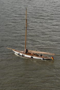 A closeup shot of a wooden sailing boat swimming on shallow waters