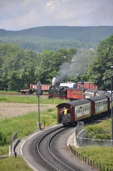 Vertical shot of a steam locomotive with old wagons of Harzer Schmalspurbahnen at the station