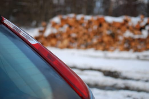 Closeup shot of the red tail light on a gray car