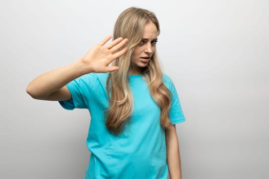 blond girl showing refusal on white background.