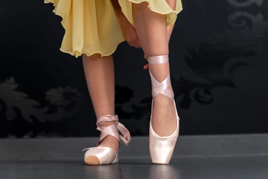 ballet shoes on the feet of a ballerina. High quality photo