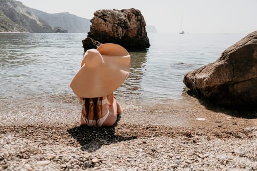 Woman travel sea. Happy tourist taking picture outdoors for memories. Woman traveler looks at the edge of the cliff on the sea bay of mountains, sharing travel adventure journey.