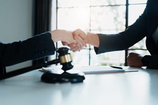 Law, consultation, agreement, contract, lawyer or attorney shakes hands to agree on the client's offer to be hired to fight the parties in court