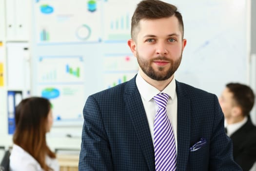 Portrait of a young smiling businessman successful entrepreneur winning meeting. Top manager with great business experience concept