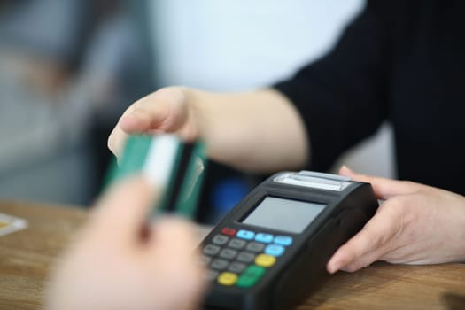 Seller offers buyer to pay for purchase credit card. Payment for goods through payment terminal concept