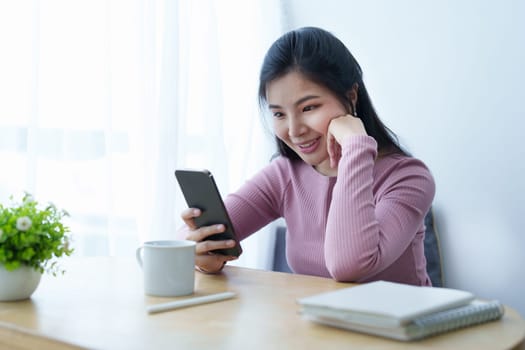 Portrait of a beautiful Asian teenage girl using a smartphone mobile.