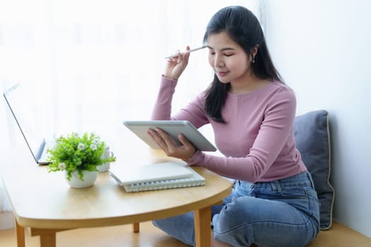 Portrait of a beautiful Asian teenage girl using a tablet computer.