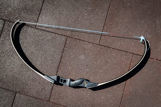 Modern sports bow lies on the sports ground at team building sports games.