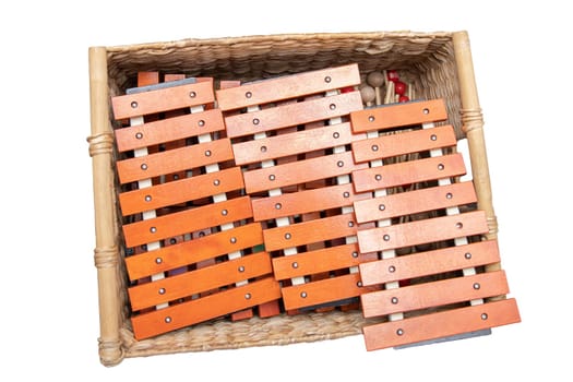 Children's wooden xylophones in a box, isolated on white, top view.