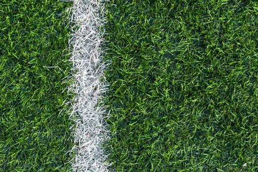 White stripe markings on the green grass of the soccer field.