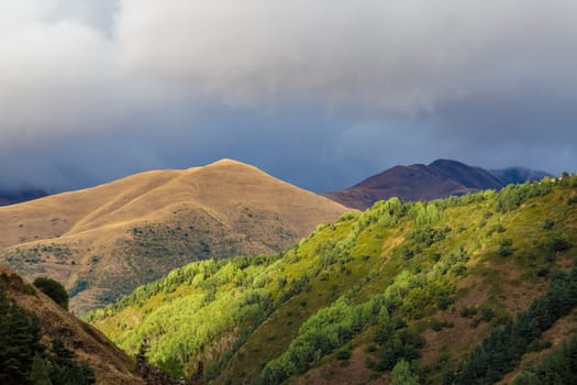 Highlands of North Ossetia. Mountains of the Caucasus. High mountains in the rays of the setting sun