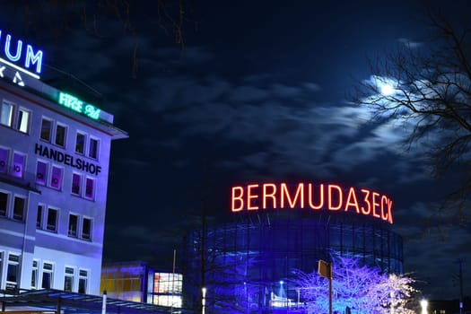 Low angle shot of an illuminated sign of the Bermuda3eck in Bochum, Germany